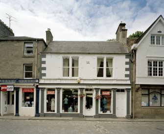 View from W showing shopfront with cast iron corinthian columns and inscription above central bay "R.R. 1872"