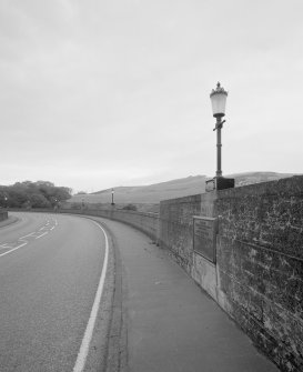 View from S showing typical lamp standard, parapet, and tarmac deck