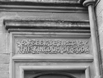 Detail of door to villa block with inscription "SEEK YE FIRST THE KINGDOM OF GOD"