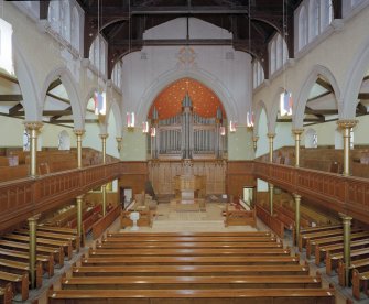 Interior view from gallery to South showing the pulpit and the organ apse.