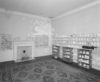 Second floor view of a bedroom with teapot and tea bowl collection.