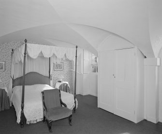 Basement view of vaulted bedroom