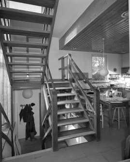 View of Kitchen open tread staircase from South