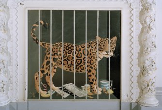 Hall, detail of painted fireboard of a caged leopard by C E Brett