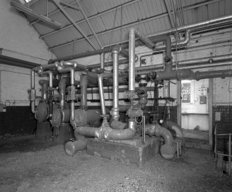 Interior view of boiler house pump room and hot water system.