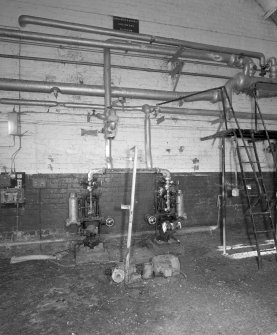 Interior view of boiler houseshowing small pumps and some of the pipework.
