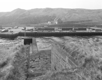 Lybster Harbour
An elevated view of the harbour looking due west, showing the protected inner harbour, the store houses and the fish smoking-kiln in the distance