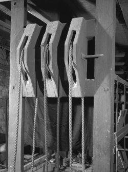 Detail of mezzanine floor pulleys at end of stage machinery frame.