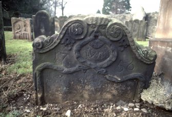 View of headstone with Green man and inscription 1756, Alva churchyard.