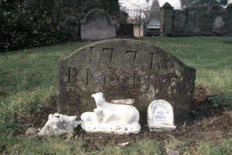 View of partly buried  headstone dated 1771 - memorial to 'Wee Bessie ' in front, Alva churchyard.