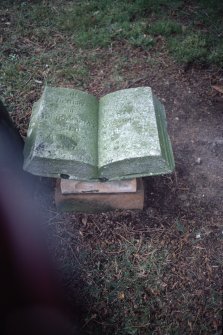 View of memorial stone in shape of open book, Dollar Old Parish Churchyard.
