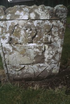 View of 17th-century headstone, with skull and possible bakers symbols, Logie Old Churchyard.
