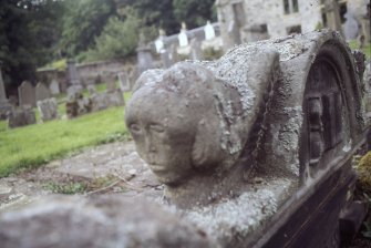 Detail of headstone showing carved head, Logie Old Churchyard.