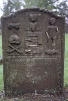 Detail of headstone to James Douglas d. 1747 showing hourglass, skull and tools, Dalry Parish Church.