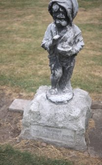 View of memorial statue of child, Tinwald Parish Church burial ground.