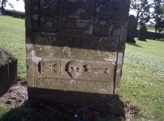 Detail of headstone to James Rew 1762 with 'smiling'skull, Garvock Parish burial ground.