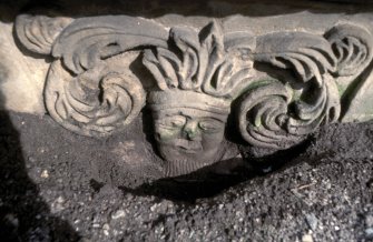 Detail of tablestone to Robert Bary d. 1682, west end with carving of a green man; Kinloss Abbey burial ground.