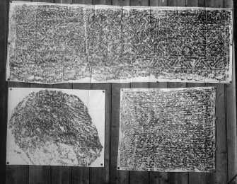 Photographic copy of three rubbings. The top rubbing shows detail of face of Rosiemarkie no.2  carved stone, Rosemarkie Parish Church. The bottom left rubbing shows detail from a fragmented Pictish symbol stone, originally from Newbigging Farm, Leslie, now in the garden of Leith Hall. The bottom right rubbing shows detail of face of  Farr cross-slab, Clachan.
