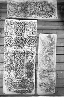 Photographic copy of three rubbings. The upper rubbing shows the lower right panel detail, and the right rubbing shows the lower left panel of face of Meigle no. 1 Pictish cross slab, now in Meigle Museum. The left rubbing shows detail of face of Dyce no.2 Pictish cross slab, Chapel Of St Fergus, Dyce. 
