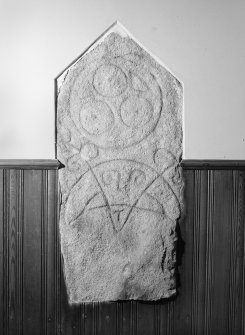 View of Kinellar Pictish symbol stone built into interior wall of church.