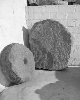 View of the Wolf Stone and a quern stone in the garden of Leith Hall. The Pictish symbol previously stood at Newbigging Farm, Leslie.