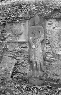 Kilberry. Medieval grave slab showing knight [No. 11] and post medieval panel showing a cockerel [No. 27]