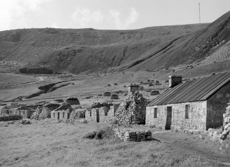 Village, Houses 5,6,7,8.
View from East along street.