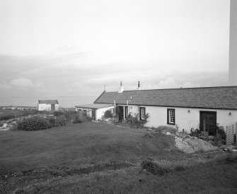 Islay, Rudh A' Mhail, Rhuvaal Lighthouse
View from S of SW side of range of keepers' houses, and adjacent out-house (left)