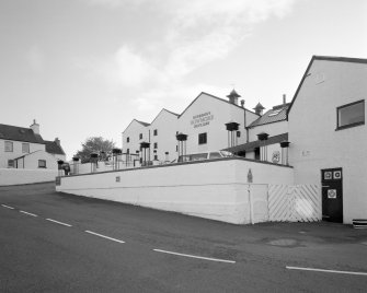 Bowmore Distillery
View from N in E yard, showing E gables of the maltings block (centre), and part of the visitors' centre (right)