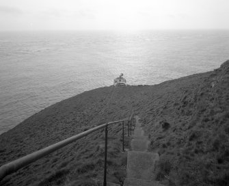 View from NE, looking down steep path and steps from lighthouse to fog horn.