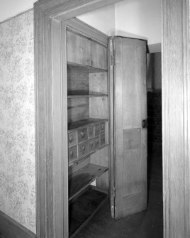 Interior.
Detail of cupboards in entrance hall showing spice drawers.