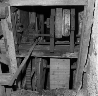 Detail of threshing machine in barn.