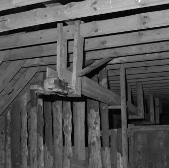 Detail of threshing machine in barn.