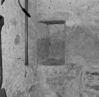 Ground floor, garden room, interior detail of embrasure in wall to left of blocked fireplace.