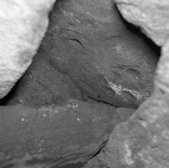 Detail of cup-and-ringmarked slab in roof of souterrain.
