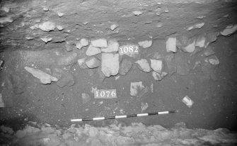 Excavation photograph: area X - patch of stones with 1076.