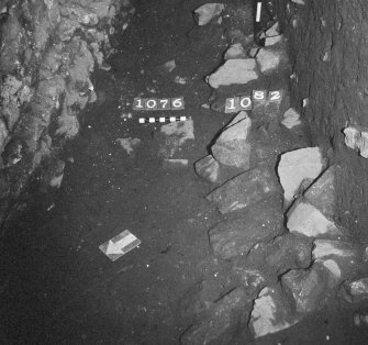 Excavation photograph: area X - patch of stones with 1076, from north-west.