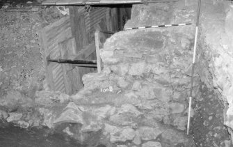Excavation photograph: area X - south wall of storekeepers house and construction 1344, from south-east.