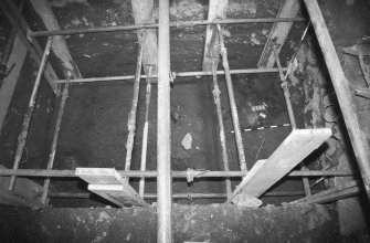 Excavation photograph: area X - hearth in NW corner of trench and rectangular stone, from east.