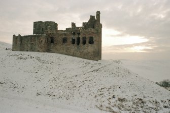 Excavation photograph : N side of castle, winter sunset.