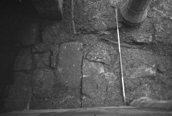 Excavation photograph : modern drain cutting masonry of ?early barmkin wall F36.