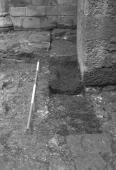Excavation photograph : close up of partially excavated foundation cut for S wall of N range, from E.