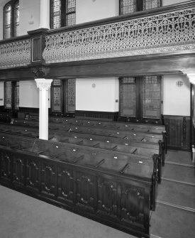 Interior. Pews and gallery column detail