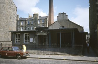 View from W showing front elevation and chimney.
