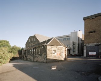 View from SW of gatehouse and offices (foreground), former maltings block (background centre) with new steel-clad block for Saladin boxes, and new whisky bond (right)
