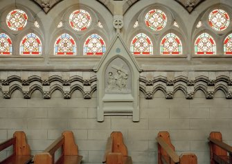 Interior. Detail of stained glass windows and station of the cross