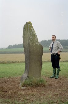 View of rubbing stone from SW, with Dr Iain Fraser (RCAHMS) in picture