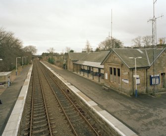 View from NW (from footbridge) showing station building and platforms