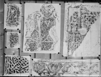 Photographic copy of six rubbings. 
The upper left rubbing shows detail from panel of the Dupplin Cross; the upper central rubbing shows detail of face of Meigle no. 29 Pictish cross slab fragment and the upper and bottom right rubbings show details of the Drosten Stone Pictish cross slab, St Vigeans no.1. The left middle and bottom rubbings are yet to be identified.

