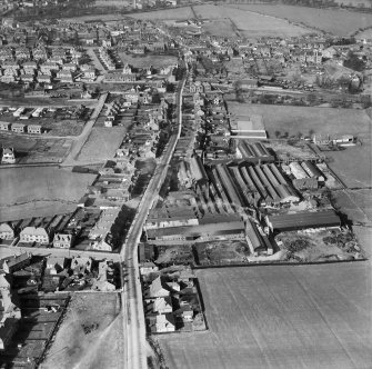 Denny, general view, showing Cruikshank and Co, Ltd, Denny Iron Works, Glasgow Road and Paris Avenue,   Mydub, Denny, Stirlingshire, Scotland, 1950. Oblique aerial photograph taken facing north.  This image has been produced from a crop marked negative.
